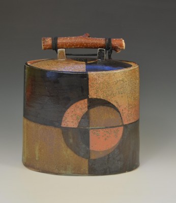Elka Adamowicz’s "Circular Division #1” is an oval box (7"x8"x5" HxLxW)  made of white stoneware, decorated with a flashing slip, black slip and a mat glaze and fired in a high-fire atmospheric kiln with the addition of soda.