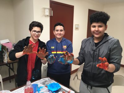 Getting their hands dirty: Students Edgar, Alexi and Kennedy work on after-school art projects.