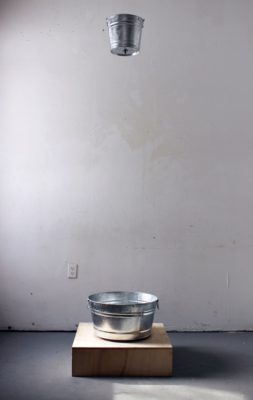 In Braden’s installation, “Waste,” water slowly drips from top bucket into bottom bucket. Guitar pickup and loop pedal beneath bottom bucket record and loop the sound of the drip. Over the course of the installation, the sound from the bucket loops into a drone of drip sounds while the actual water evaporates before it can accumulate inside the bottom bucket.