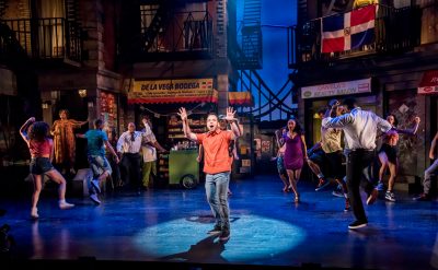 The cast of “In The Heights,” with Broadway star Robin De Jesús (center) as Usnavi.