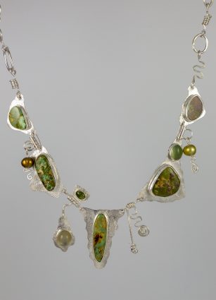In "The Grass is Greener," Blair Anderson combines sterling silver, Cerillos turquoise, labradorite, pearl, green tourmaline and moonstone. She says "the whimsical design reminds us that what we have is often greater than what we pine for."