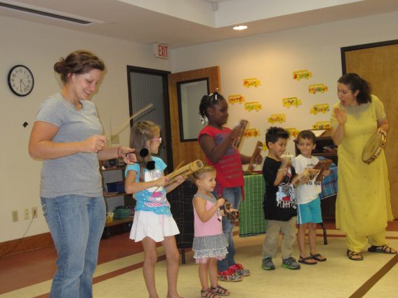 Ariana Ross, Story Tapestries' executive director and master teaching artist, leads a family performance at a public library.