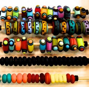 Brightly colored handmade glass beads come in different shapes, sizes and designs.