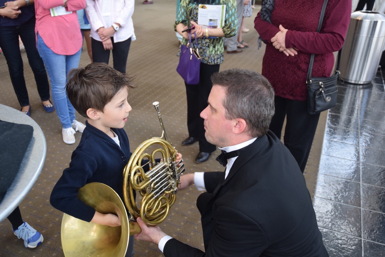 Matthew Apter, 6, of Rockville meets National Philharmonic hornist Mark Wakefield.